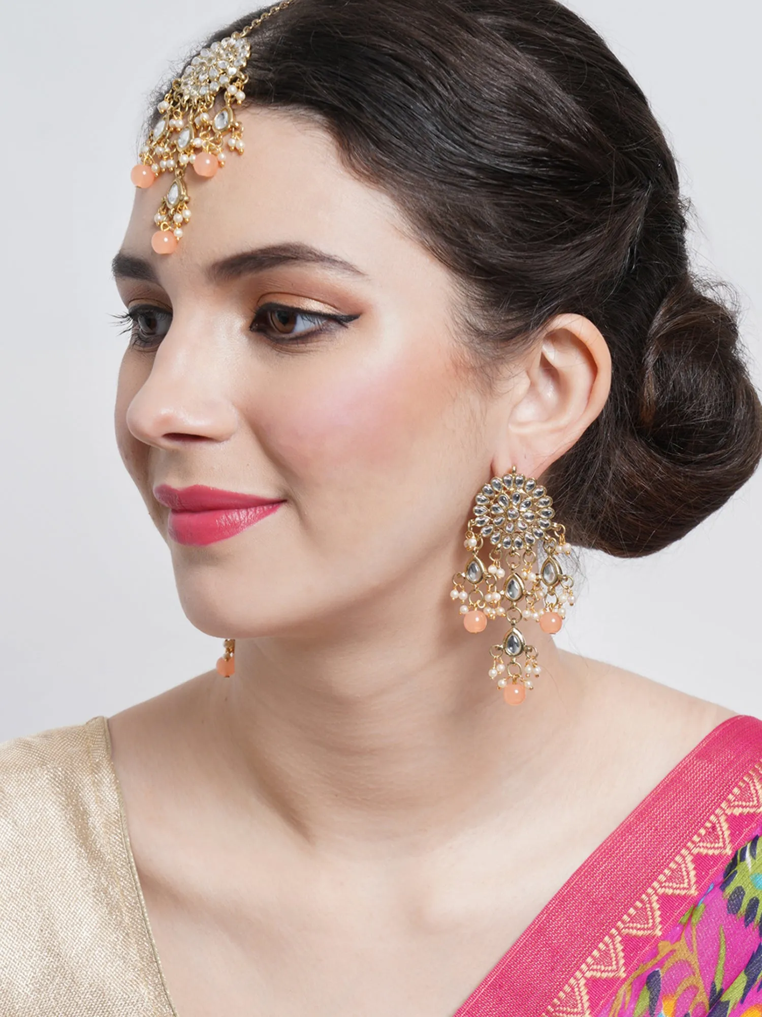 Gold Plated Embellished Peach Kundan Tassel Earrings with Maangtikka